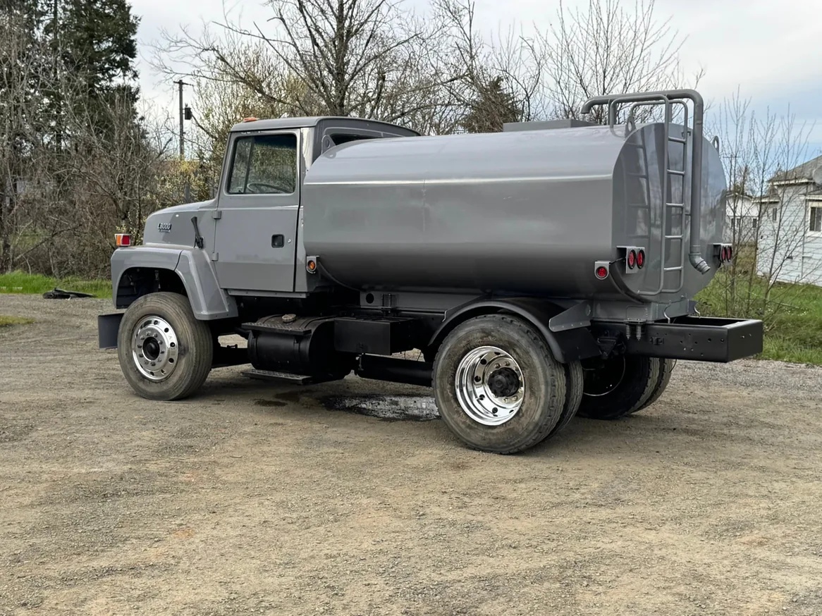 Gray water truck on a gravel yard, excavation contractor
