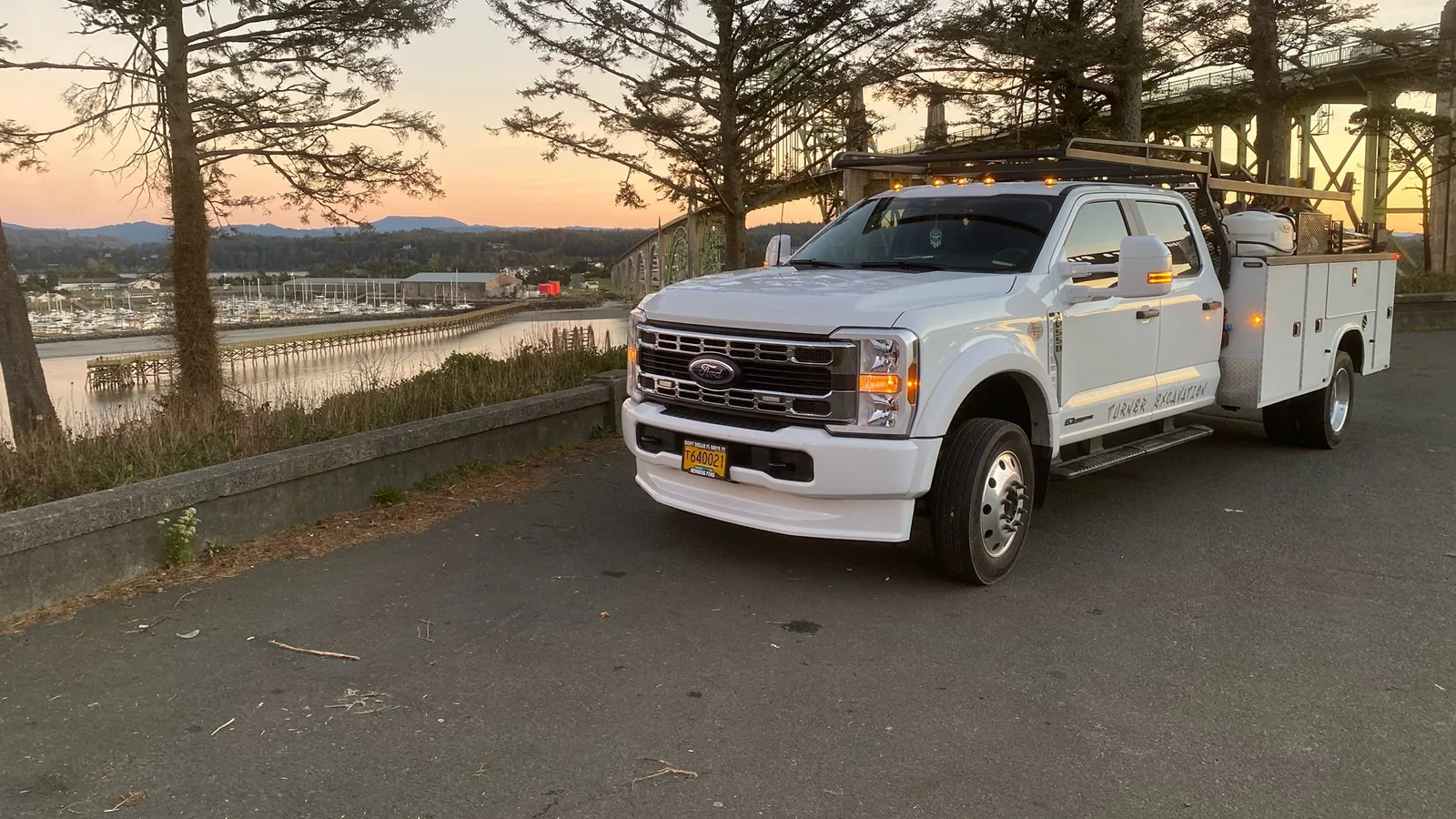 Work pickup parked above the bay at dusk, excavation contractor