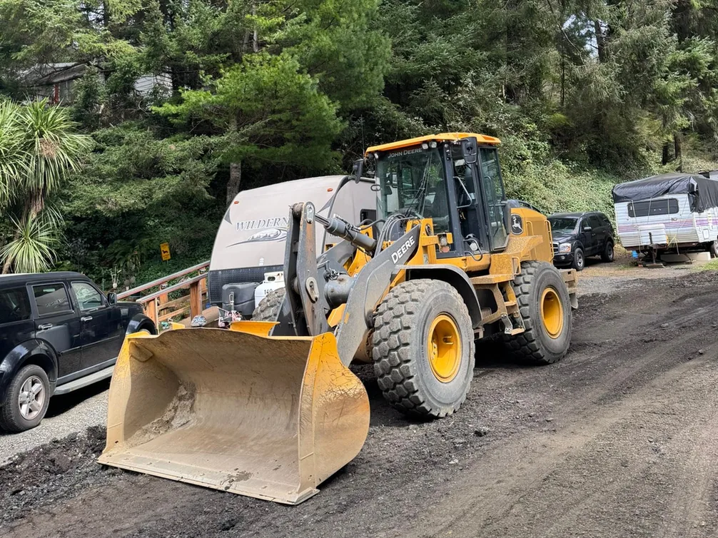 Wheel loader on a road stripped down to its base, demolition