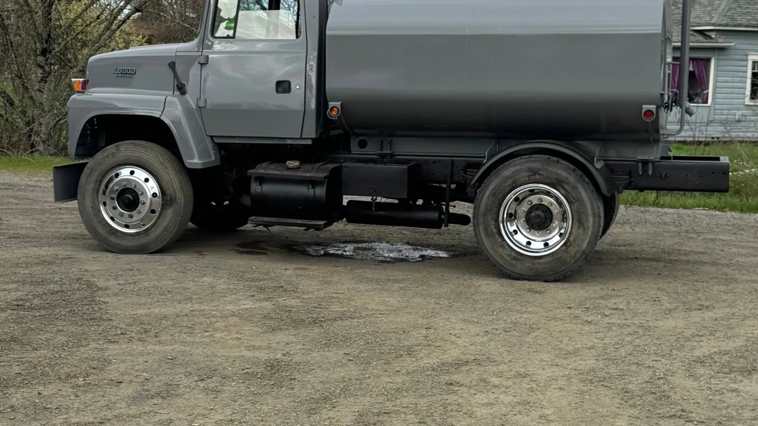 Gray water truck on a gravel yard, excavation contractor services